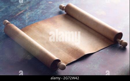 An Open Blank Scroll on a Blue Rustic Wooden Table Stock Photo