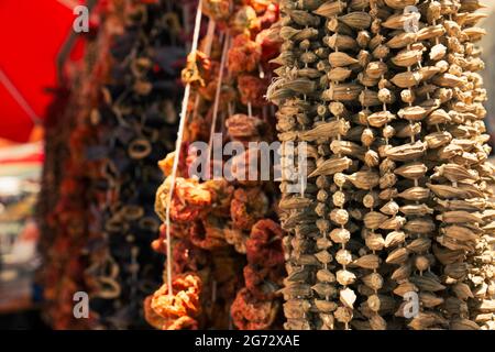 Dried okras and other vegetables in display under natural sunlight, outdoors. Stock Photo