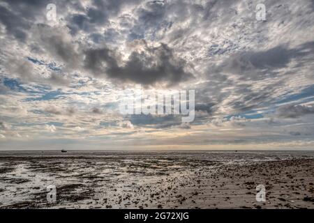 A cloudy evening sky over the shores of The Wash at low tide, between Heacham & Snettisham in Norfolk. Stock Photo