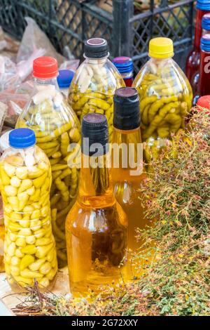 homemade vinegar and pickles in the bottles at the local market Stock Photo