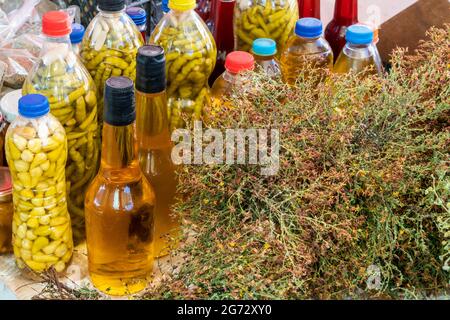 homemade vinegar and pickles in the bottles at the local market Stock Photo