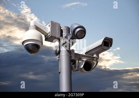 Many CCTV cameras on the background of the sky at sunset Stock Photo