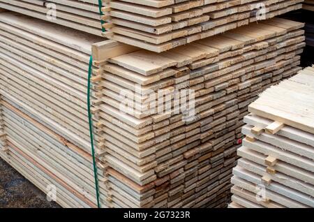 large stacks of wooden planks at the building material depot. Stock Photo