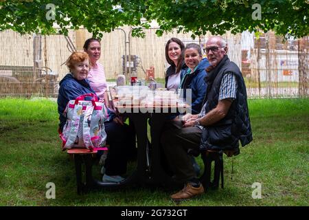 East Molesey, Surrey, UK. 8th July, 2021. Guests enjoying picnics at the RHS Hampton Court Palace Garden Festival. Guests were required to provide a negative Covid-19 test or proof of their double Covid-19 jabs before being allowed entry to the festival. Credit: Maureen McLean/Alamy Stock Photo