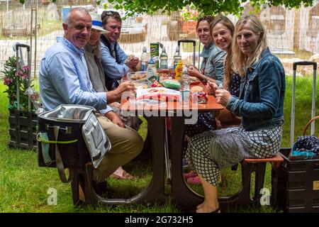 East Molesey, Surrey, UK. 8th July, 2021. Guests enjoying picnics at the RHS Hampton Court Palace Garden Festival. Guests were required to provide a negative Covid-19 test or proof of their double Covid-19 jabs before being allowed entry to the festival. Credit: Maureen McLean/Alamy Stock Photo