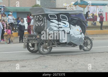 Arequipa Peru carnival Mickey mouse and Buzz light year cat white road driving canopy people watch watching painted side cover sign signs cats car cat Stock Photo