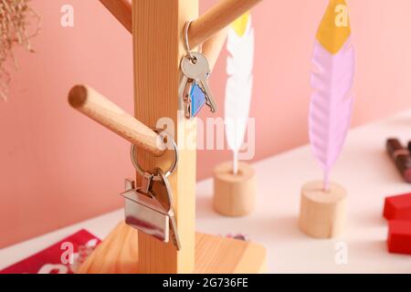 Holder with keys on shelf near color wall, closeup Stock Photo