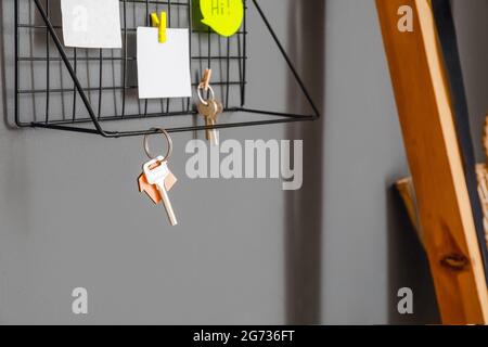 Shelf with keys hanging on dark wall, closeup Stock Photo