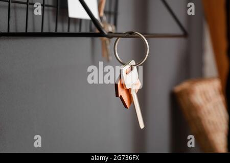 Shelf with key hanging on dark wall, closeup Stock Photo