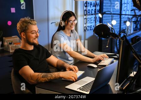 Young programmers working with computer in office at night Stock Photo