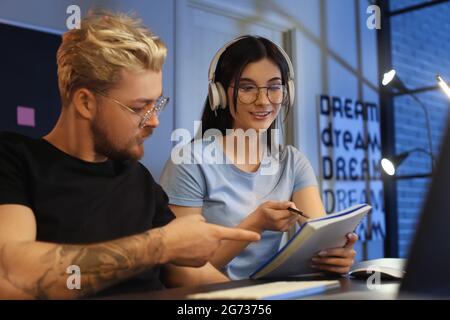 Young programmers working in office at night Stock Photo