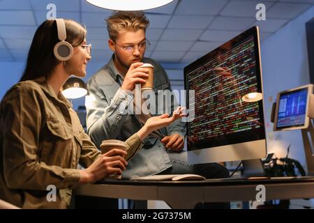 Young programmers working in office at night Stock Photo