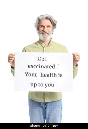 Senior man holding poster with text GET VACCINATED. YOUR HEALTH IS UP TO YOU on white background Stock Photo