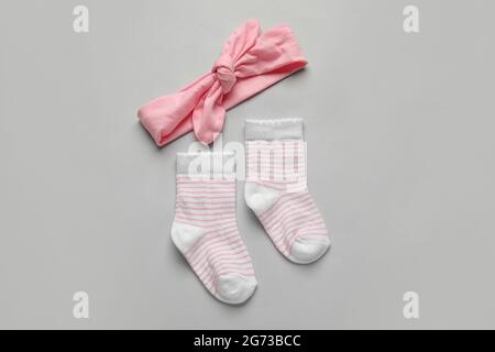 Baby socks and headband on light background Stock Photo