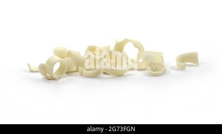 White Chocolate Curls Isolated On White Background. Group of chocolate shavings. Chocolate roll. Stock Photo