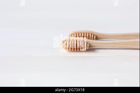 Bamboo toothbrushes on white table background, minimal eco friendly and sustainability concept Stock Photo