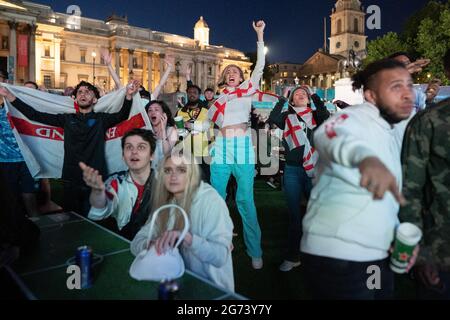 EURO 2020: England vs Denmark. England fans celebrate in Trafalgar Square as England wins 2-1 in extra time against Denmark at the semi-finals. UK. Stock Photo