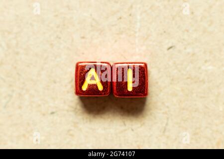 Metallic color alphabet letter block in word AI (Abbreviation of artificial intelligence) on wood background Stock Photo