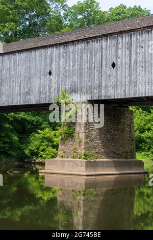 A vertical shot of the Schofield Ford Covered Bridge in Tyler State Park, Pennsylvania on a sunny day Stock Photo