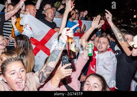 London, UK. 10 Jul 2021. England fans chanting in Leicester square. The anticipation for the finals are being built up and ready to lead to a breaking point. Public attitudes towards England Team. Credit: Stefan Weil/Alamy Live News Stock Photo