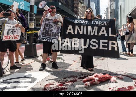 Animal rights activists protest outside designer store Yves Saint Laurent in New York City on July 10, 2021. The activists call on the luxury label to join Canada Goose and Saks Fifth Avenue, which recently announced that they would phase out the sale of fur products in their stores. (Photo by Gabriele Holtermann/Sipa USA) Credit: Sipa USA/Alamy Live News Stock Photo