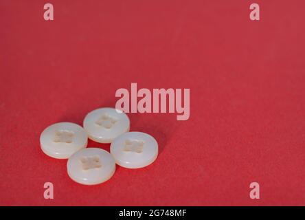 Two pairs of white buttons. Selective focus points. Blurred background Stock Photo