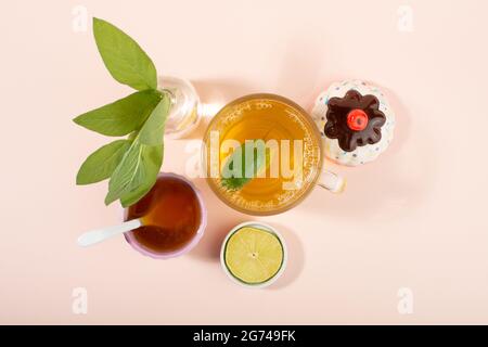 Cup of sage herbal tea, fresh sage leaves, honey and lemon. Home remedies. Top view. Stock Photo
