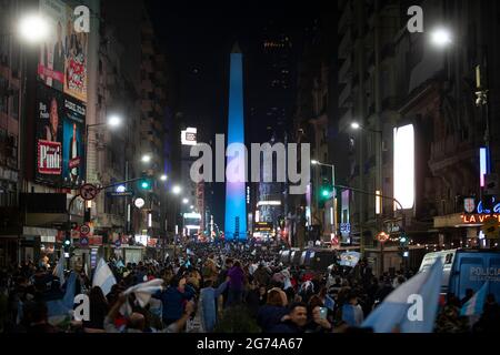 Buenos Aires, Argentina. 10th July, 2021. Fans celebrate after Argentina's national football team won the Copa America final match against Brazil, in Buenos Aires, Argentina, on July 10, 2021. Credit: Martin Sabala/Xinhua/Alamy Live News Stock Photo