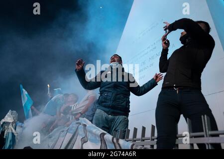 Buenos Aires, Argentina. 10th July, 2021. Fans celebrate after Argentina's national football team won the Copa America final match against Brazil, in Buenos Aires, Argentina, on July 10, 2021. Credit: Martin Sabala/Xinhua/Alamy Live News Stock Photo