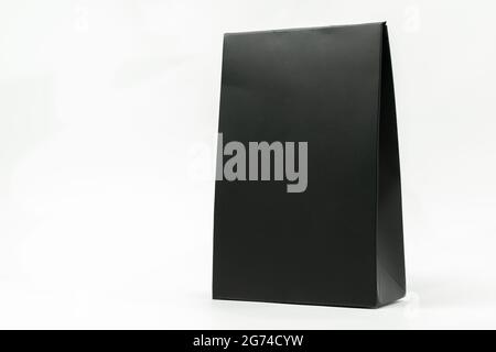 Isolated a black paper packaging, hard paper package on white background. Stock Photo
