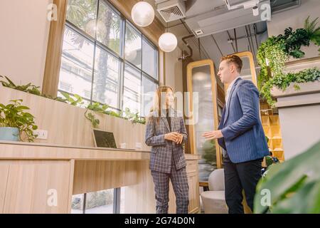 Businesspeople talking together in modern office for business contact or connection. Stock Photo