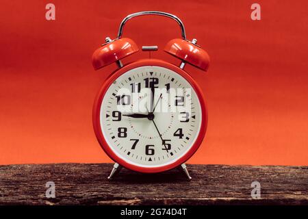9 o'clock retro clock on wooden with red sun dusk dawn day sky background. Stock Photo