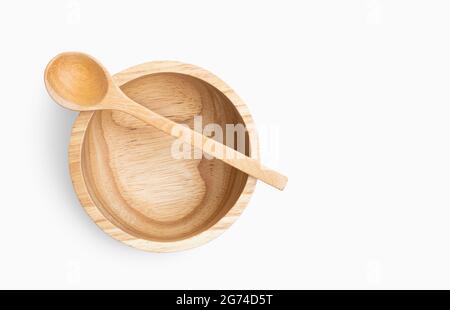 Isolated empty wooden bowl and spoon on white background, close up, top view image of bowl with spoon on bowl. Natural line pattern in wooden bowl, cl Stock Photo
