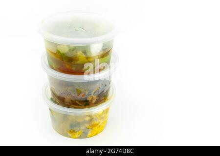 Take out food, Thai food in small container for sell in supermarket, stack container with food on white background, isolated image. Fat and short shap Stock Photo