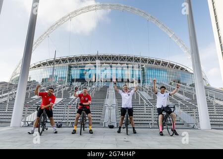 Wembley Park, UK. 11th July, 2021. Dan, Steve, Glenn, and Ben, cycled 29 miles this morning to see the famous arch ahead of tonights historic match. Wembley Stadium will host the Euro 2020 Final between Italy and England this evening. It is the first major final that England will have played in since winning the World Cup in 1966. Credit: amanda rose/Alamy Live News Stock Photo