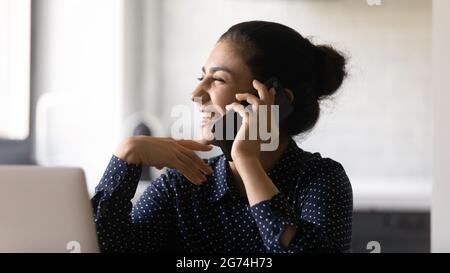 Excited manager talking on mobile phone, getting good news Stock Photo
