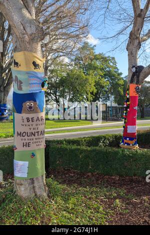 'Yarnbombing' (knitted street art' on trees in Tauranga, New Zealand. The designs are inspired by children's books. Stock Photo