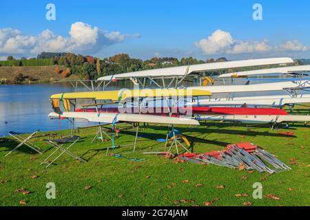 Racing boats on the shore of Lake Karapiro, New Zealand, one of the country's premiere rowing venues Stock Photo
