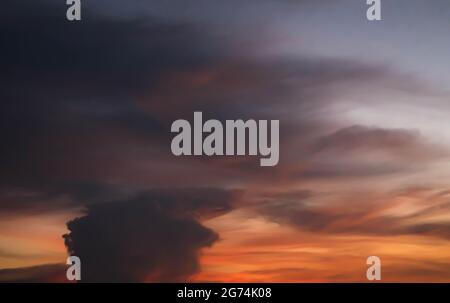 Giant dark cloud. Storm Clouds at Sunset abstract weather season. Stock Photo