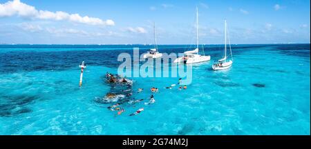 People snorkelling around the ship wreck near Bahamas in the Caribbean sea. Stock Photo