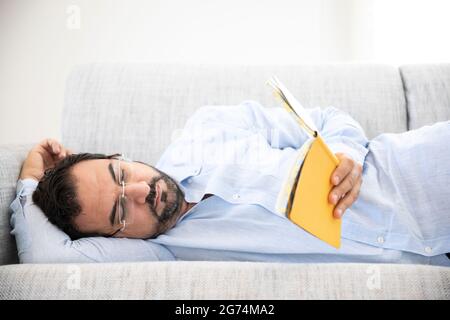 middle aged man reading at home Stock Photo