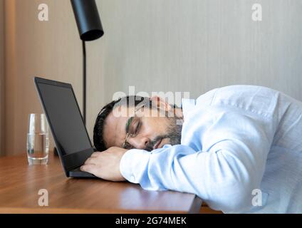 arab man fallen asleep at his computer Stock Photo