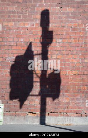 Shadow of traffic light on brick wall, Wellington, North Island, New Zealand Stock Photo