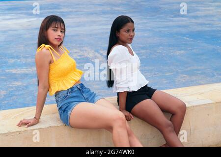 Two friends sitting in the park Stock Photo