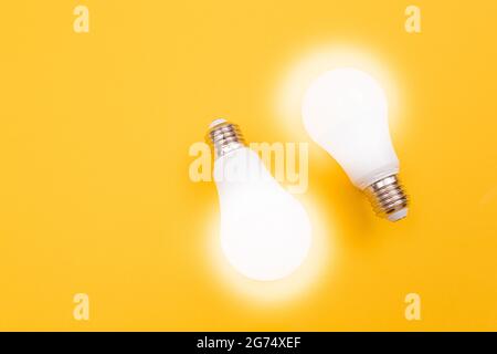 A Power Saving Lamps on Yellow Background - Top View Stock Photo