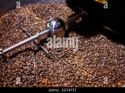 Coffee beans in the roasting machine Stock Photo