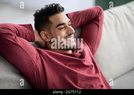 Closeup of happy arab man chilling at home Stock Photo