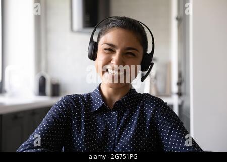 Happy funny Indian student wearing headphones and microphone Stock Photo