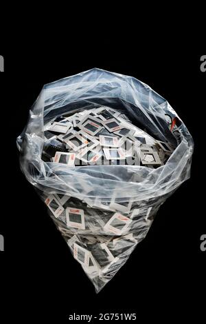 A plastic bag of rejected/unwanted old slide transparenies on black background. Stock Photo