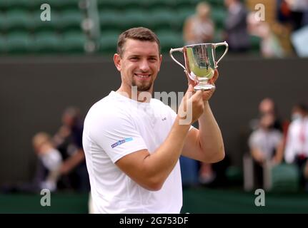 Joachim Gerard celebrates with his trophy after winning the Gentlemen's Wheelchair Singles Final against Gordon Reid on court 3 on day thirteen of Wimbledon at The All England Lawn Tennis and Croquet Club, Wimbledon. Picture date: Sunday July 11, 2021. Stock Photo